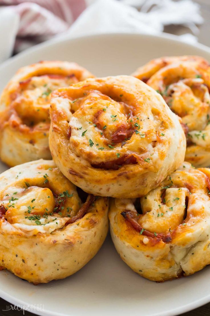 some food is on a white plate and it looks like they have been rolled up