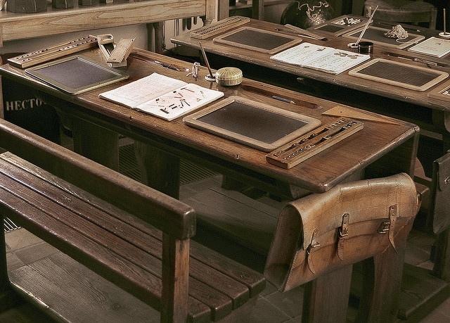 two wooden desks sitting next to each other