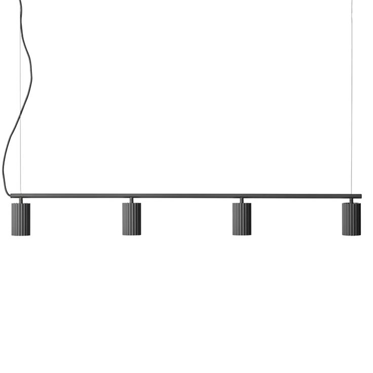 three lights hanging from the ceiling in front of a white wall with black bars on it