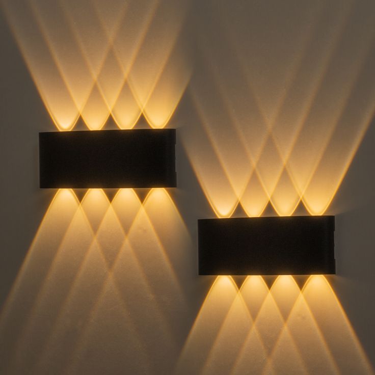 two rectangular lights are lit up on the wall