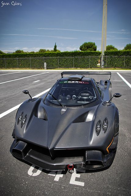 a grey sports car parked in a parking lot