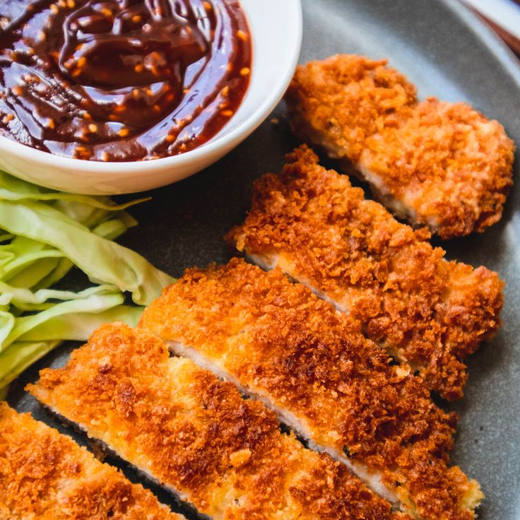 some food is laying out on a plate with sauce and lettuce next to it