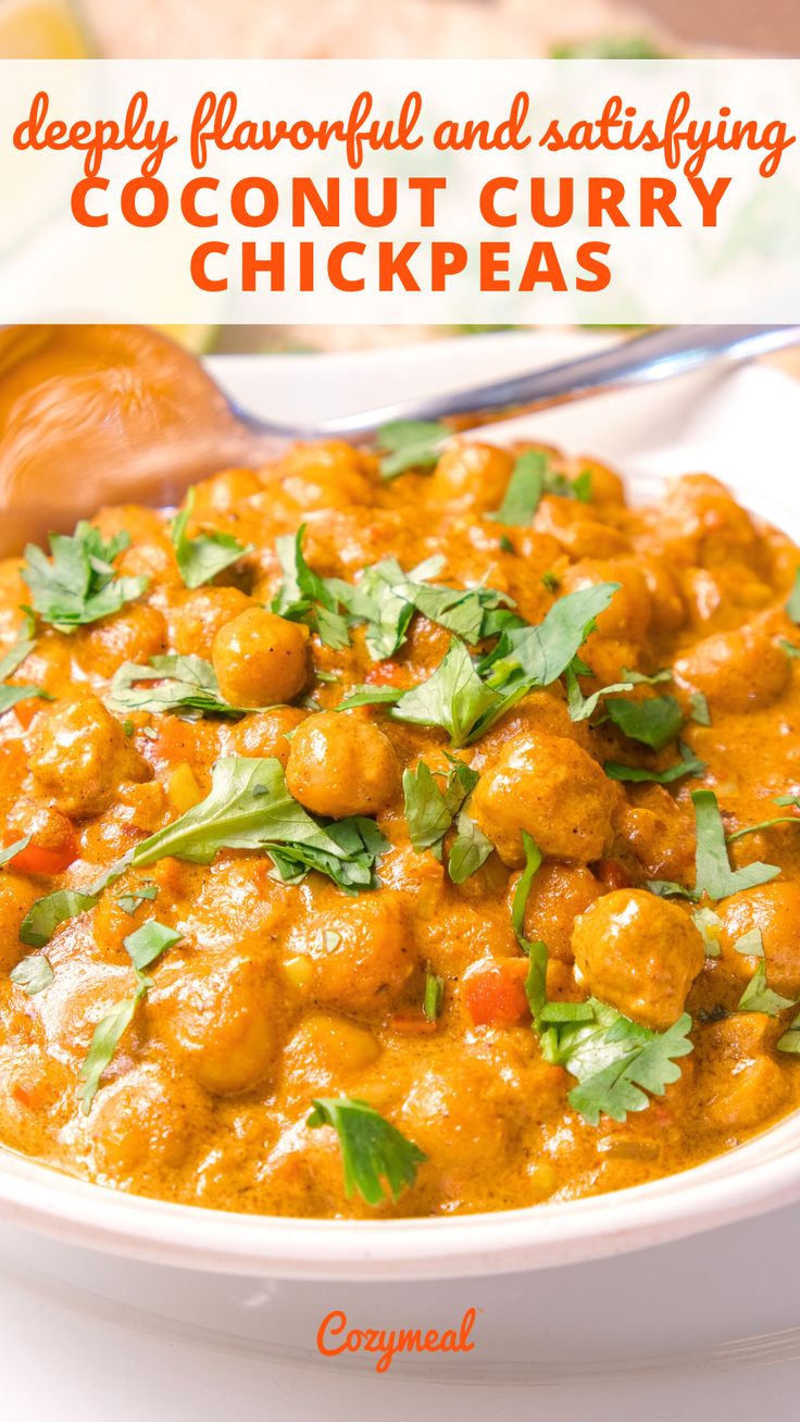 a white bowl filled with chicken curry and garnished with cilantro