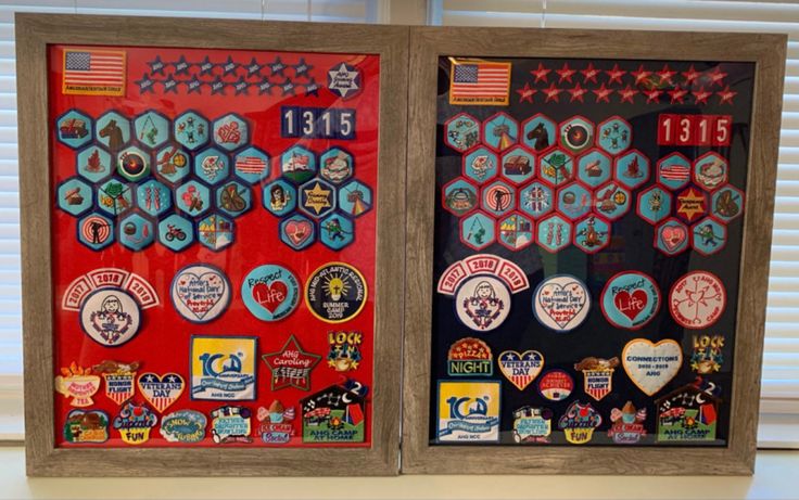 two framed pictures with different badges on them