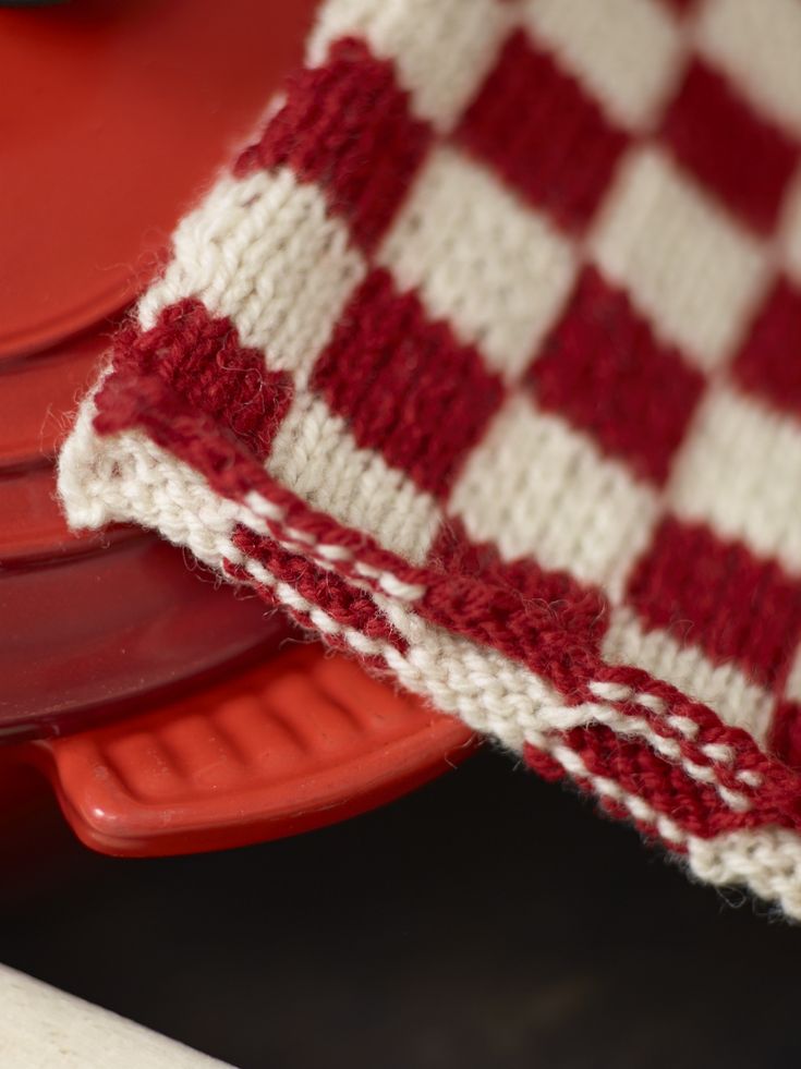 red and white checkered dishcloth sitting on top of an orange plate