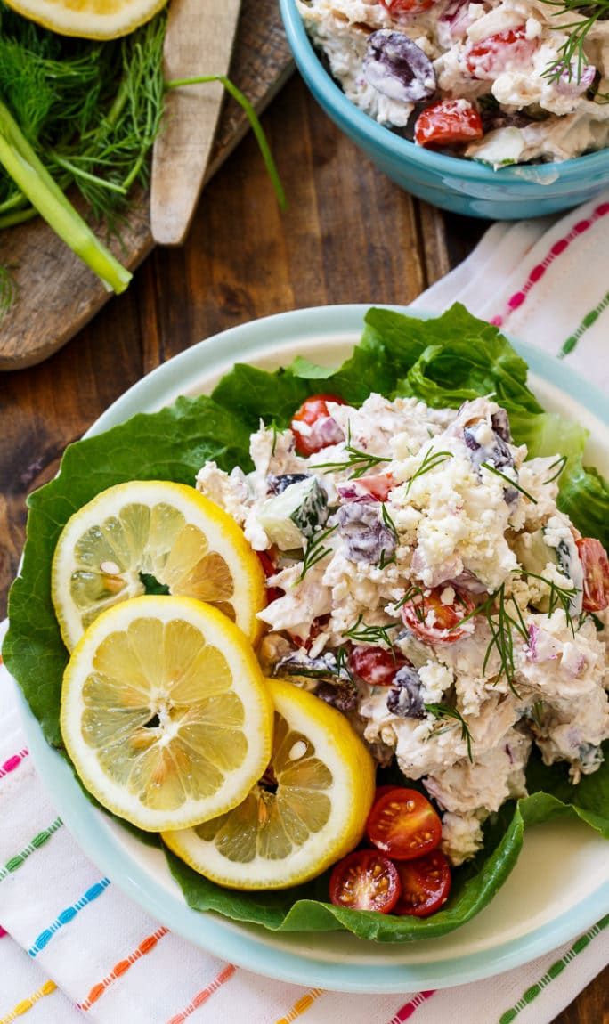 two plates filled with salad and lemon slices