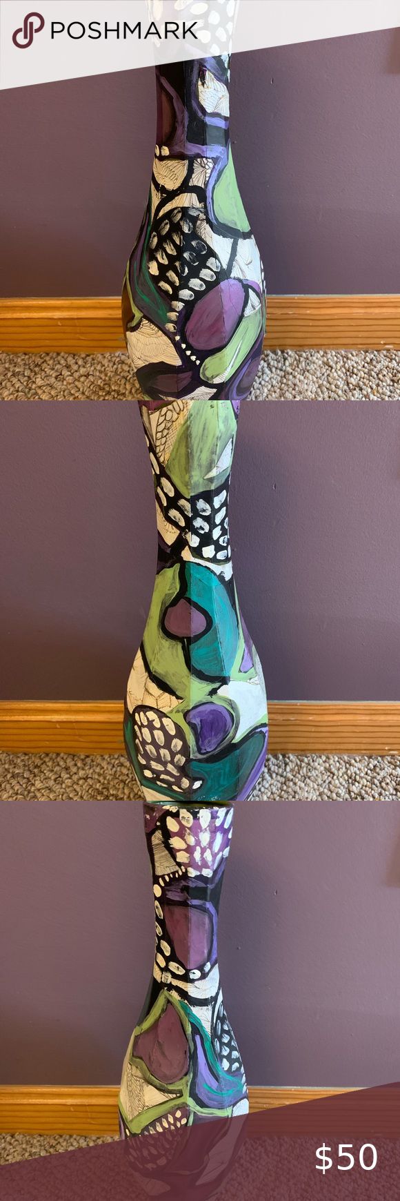 a tall vase sitting on top of a table next to a sign that says poshmark