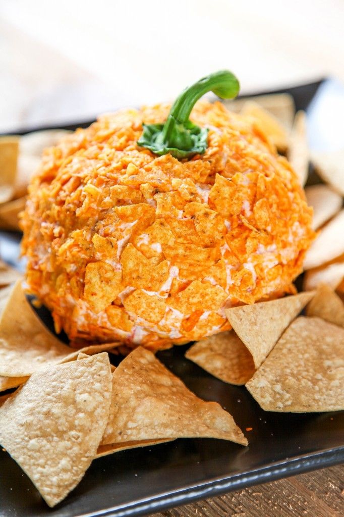 an orange cheese ball surrounded by tortilla chips