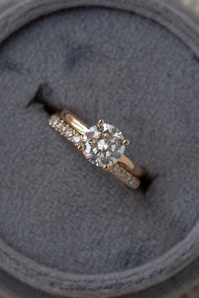 an engagement ring sits on top of a cushion