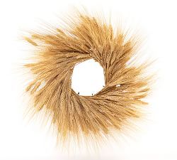 a wreath made out of dried grass on a white background