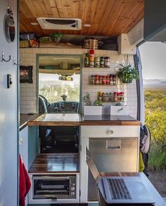 the interior of a small camper with open shelves