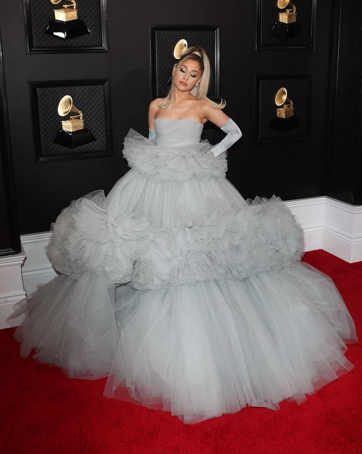 lady in grey gown standing on red carpet