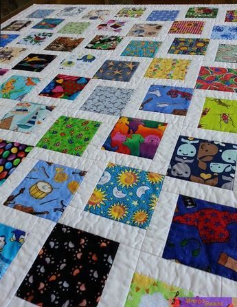 a large quilt made with many different colored squares on it's sides and bottom