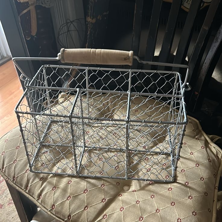 a metal basket sitting on top of a chair