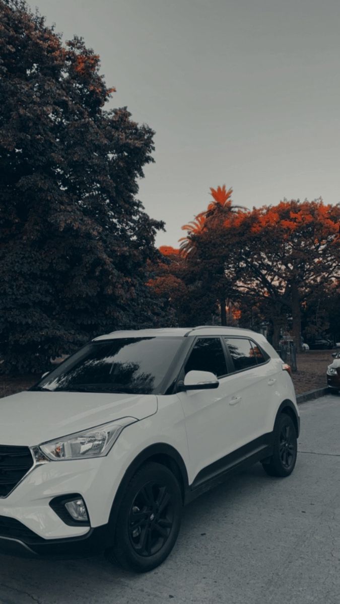 a white car is parked on the street