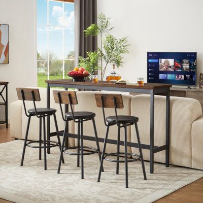 a living room filled with furniture and a flat screen tv on top of a wooden table