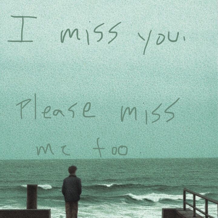 a man standing on top of a pier next to the ocean with writing on it