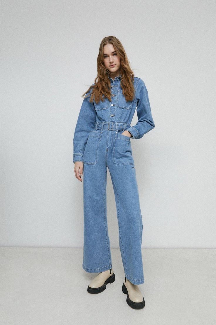 Inject a utilitarian sensibility into everyday looks with this denim boilersuit. Designed in a wide leg style with ballooned sleeves, a collared neckline, button front and classic patch pockets, it comes complete with a matching belt. Model wears a size 8. Denim Blue Relaxed Fit Utility Jumpsuit, Boilersuit Women, Washed Blue Cotton Utility Denim Jumpsuit, Dark Wash Long Sleeve Utility Denim Jumpsuit, Utility Style Button-up Denim Jumpsuit, Denim Boiler Suit, Long-sleeve Cotton Denim Utility Jumpsuit, Black Jumpsuits, Womens Denim