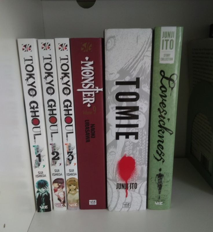 a row of books sitting on top of a white book shelf next to each other