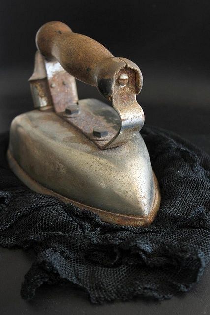 an old iron sitting on top of a black cloth