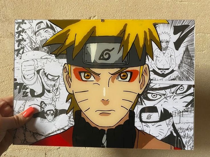 a hand holding up a piece of paper with an image of naruto