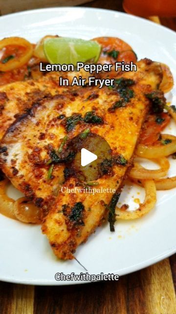 lemon pepper fish in air fryer on a white plate