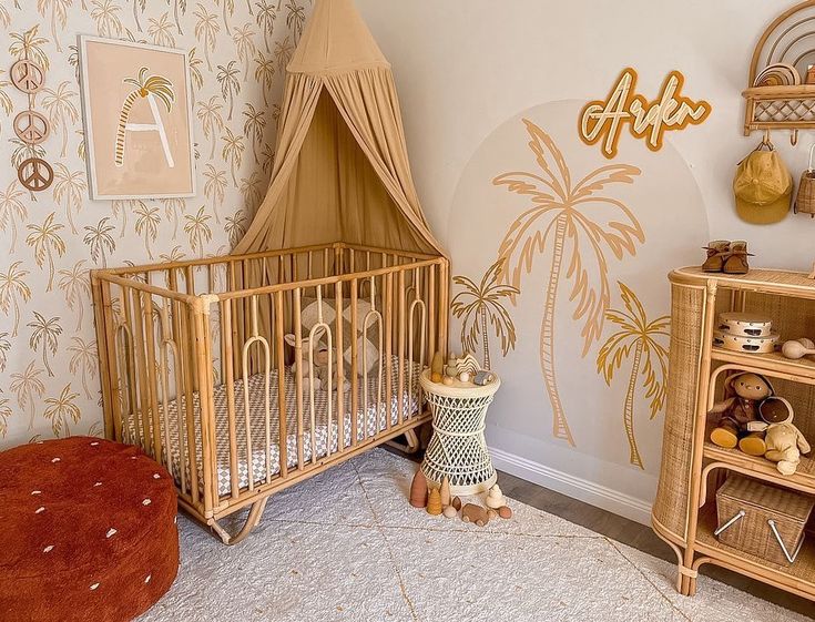 a baby's room with a palm tree wallpaper and a crib in the corner