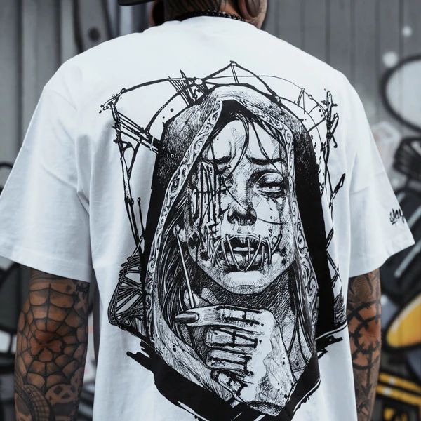 a man wearing a white t - shirt with an image of a woman's face on it