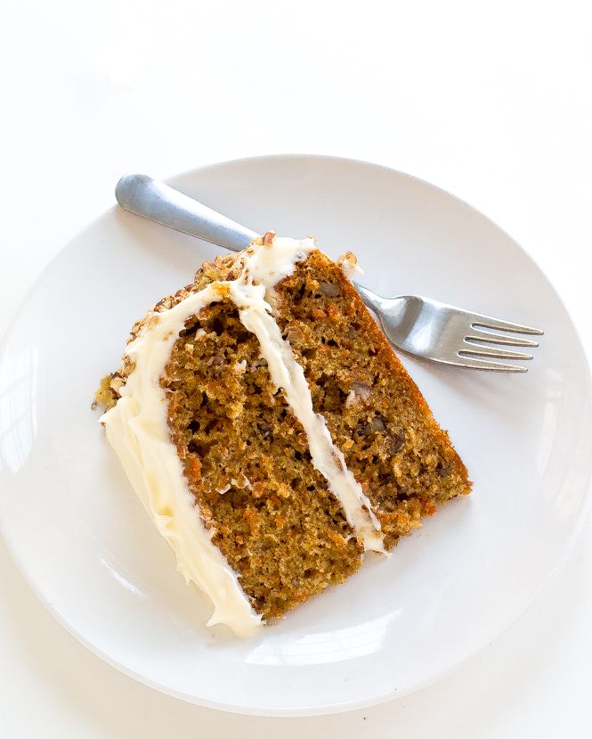 a piece of carrot cake on a plate with a fork