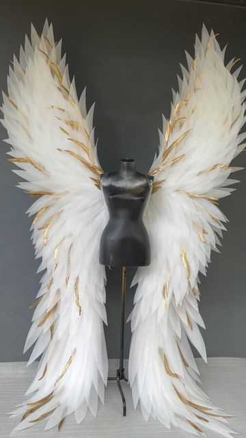 a mannequin with white and gold wings on it