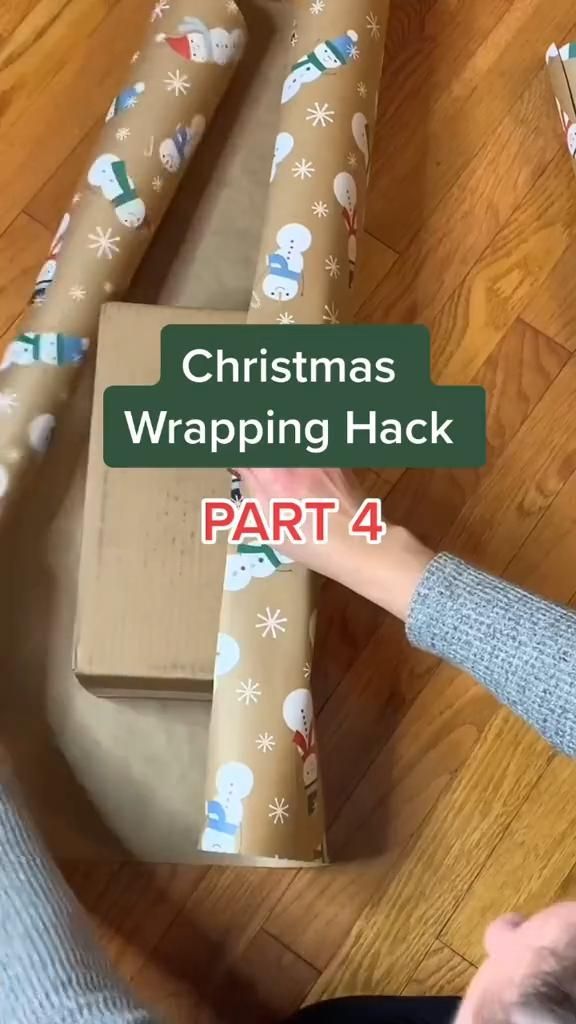 someone wrapping christmas presents on the floor with text overlay that reads, christmas wrapping hack part 4