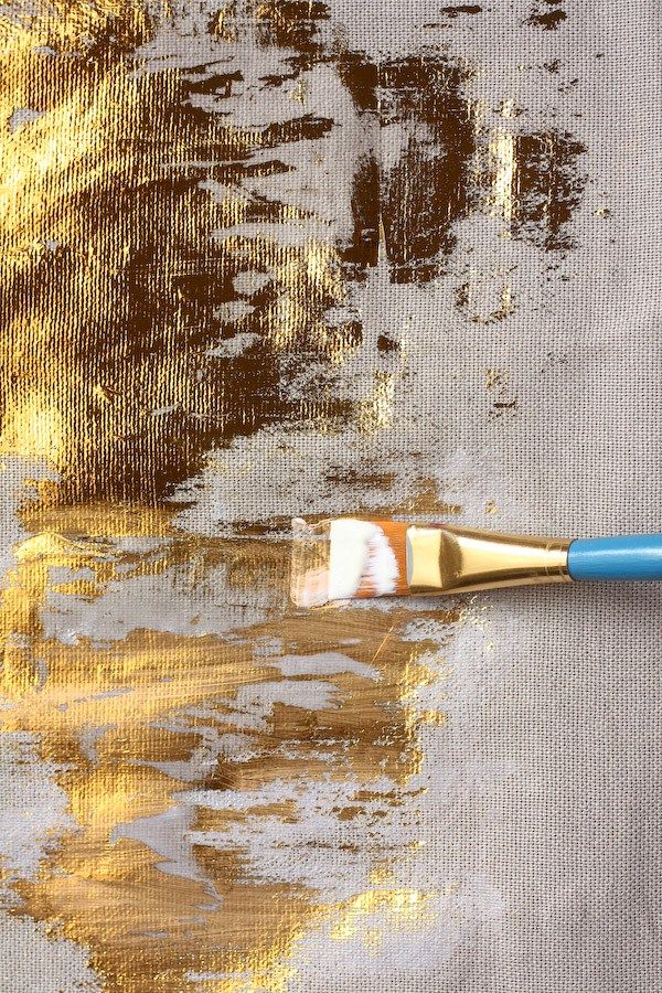 a brush with yellow and brown paint on it