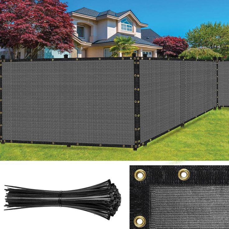 a large black privacy fence in front of a house