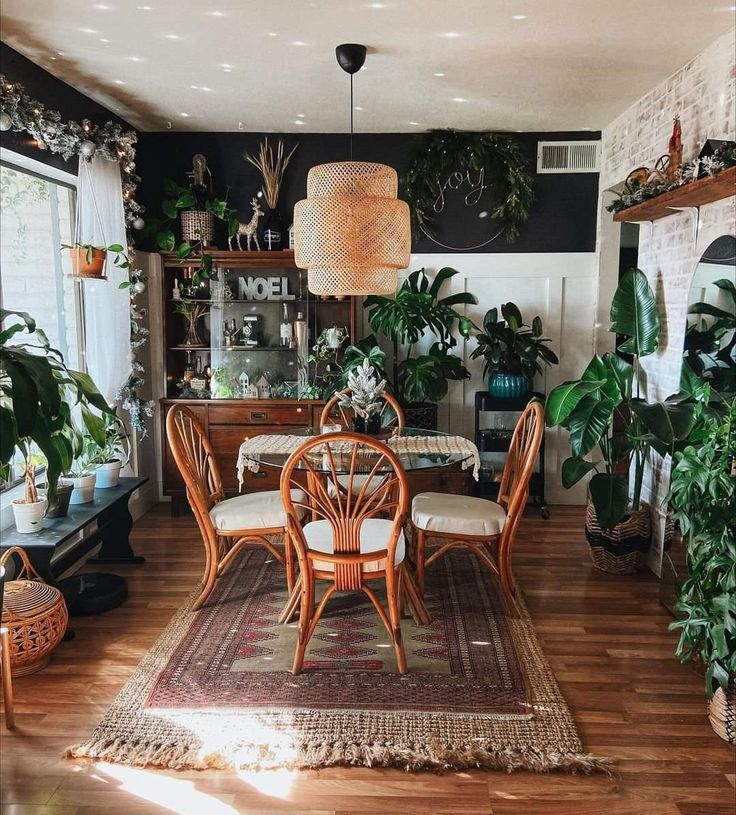 a living room filled with furniture and lots of plants on top of a hard wood floor