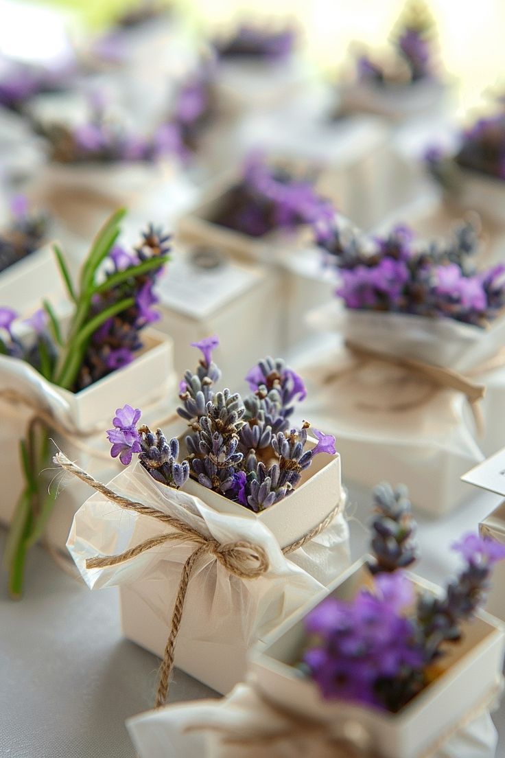 small white boxes with lavender flowers tied in twine