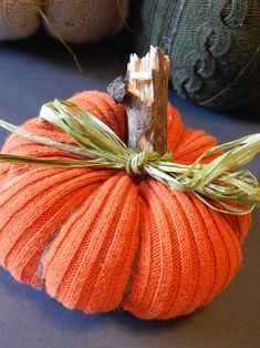 an orange knitted pumpkin sitting on top of a table