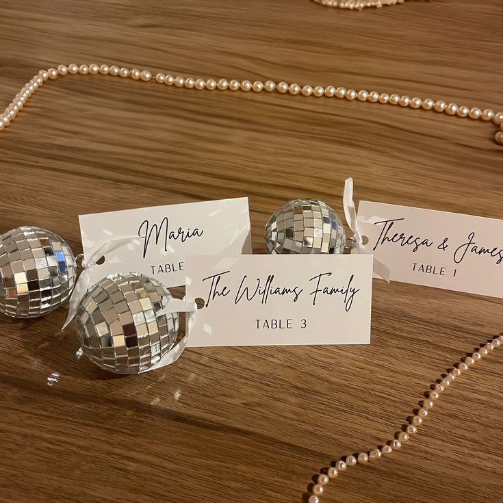 three disco ball place cards on a table