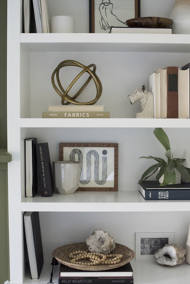 the shelves are filled with books and other decorative items