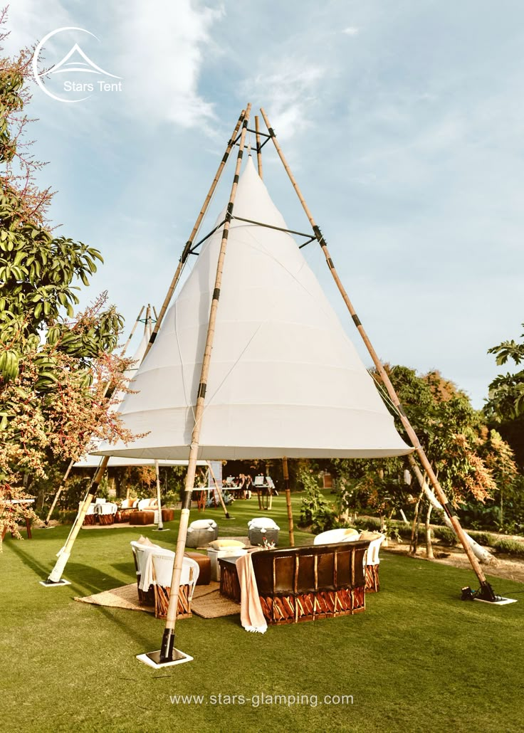 a large white tent set up in the grass