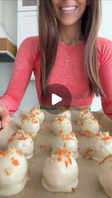 a woman is preparing some food on a tray with carrots and cream cheese balls