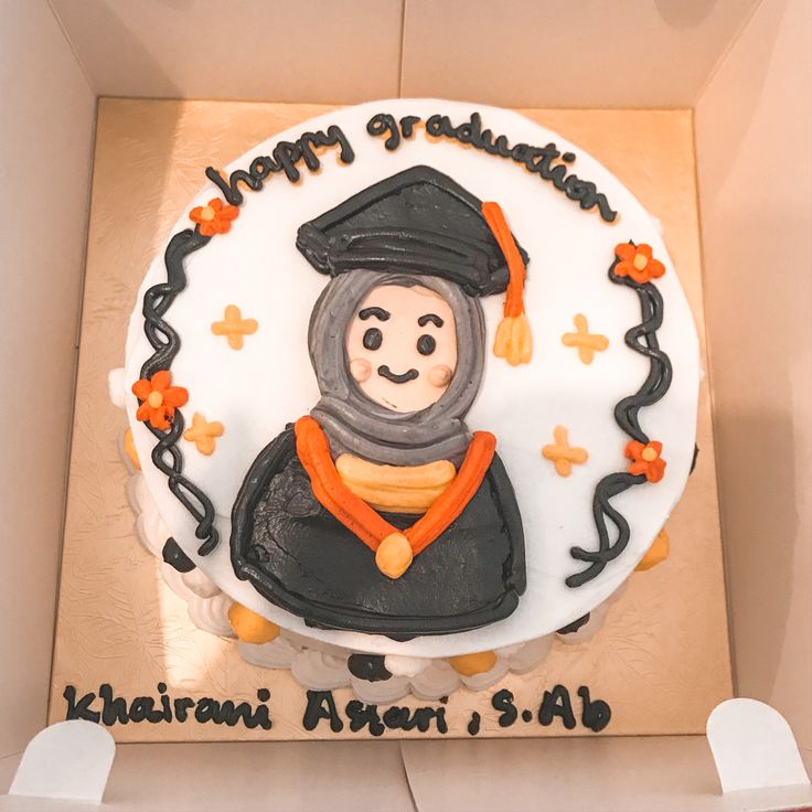 a birthday cake with an image of a graduate on it