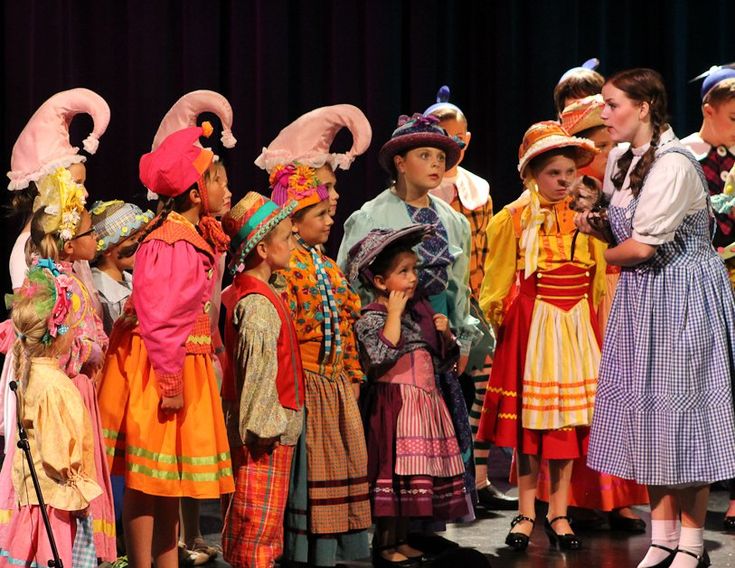 a group of children standing next to each other on a stage