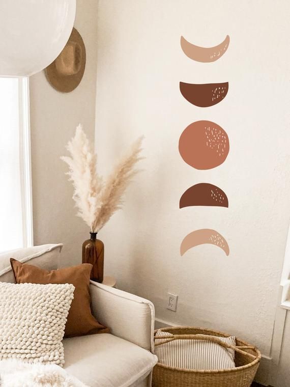 a living room filled with furniture and wall decals on the walls, along with a wicker basket