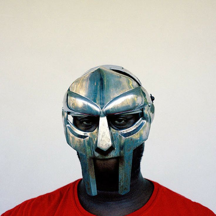 a man in a red shirt wearing a metal mask