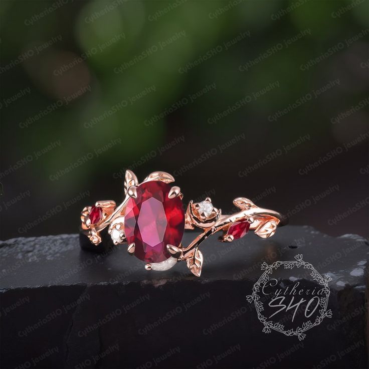 a red ring with leaves on it sitting on top of a black piece of wood