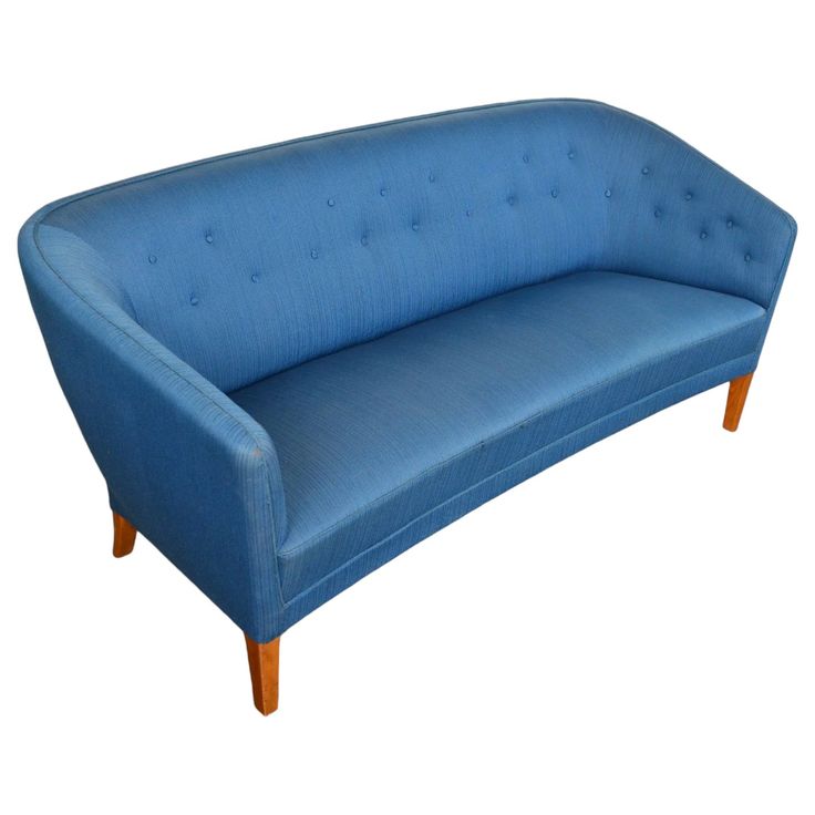 a blue couch sitting on top of a white floor