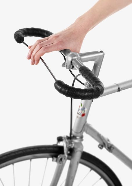 a person is holding onto the handlebars of a bicycle with their hand on it