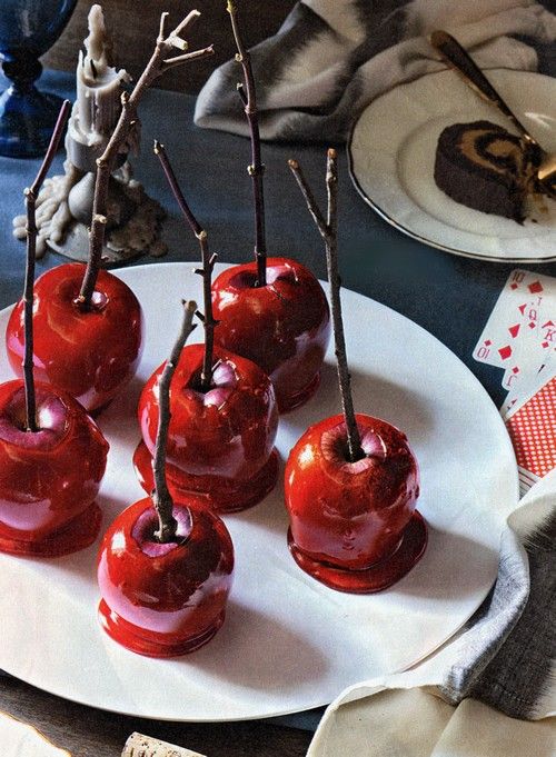 several cherries on a white plate with forks