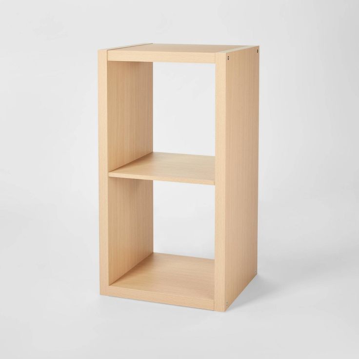 a wooden shelf with two shelves on each side and one section missing from the top