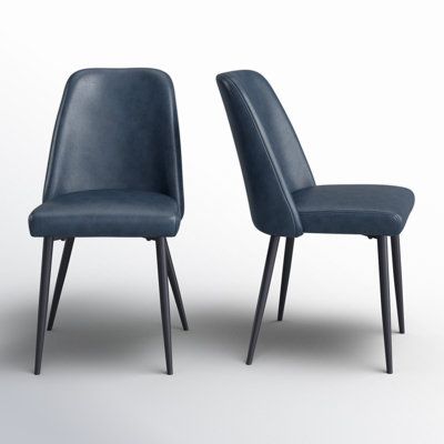 This 2-piece set of modern dining chairs brings sleek sophistication to your dining area. Featuring an armless design and splayed legs, these chairs are crafted with engineered wood frames in a sleek black finish, while the legs are made from metal for a contemporary touch. Each chair is upholstered in solid-hued faux leather and filled with foam for a comfortable dining experience. We love that the plastic glides on the feet protect your floors from scratches. With a weight capacity of 260 lbs. Navy Blue Dining Chairs, Green Chair, Modern Dining Chairs, Dining Experiences, Dining Area, Engineered Wood, Side Chairs, Wood Frame, Dining Chairs